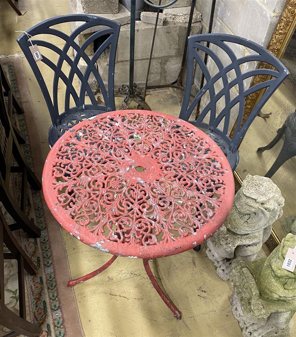 A circular painted aluminium garden table, 60cm diameter together with two garden chairs